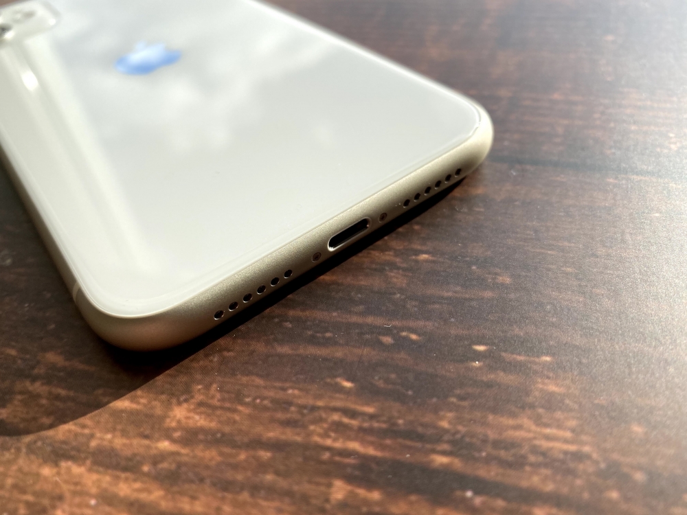 The white iPhone 11 speaker area on the table