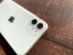 The white iPhone 11 dual camera area on the table