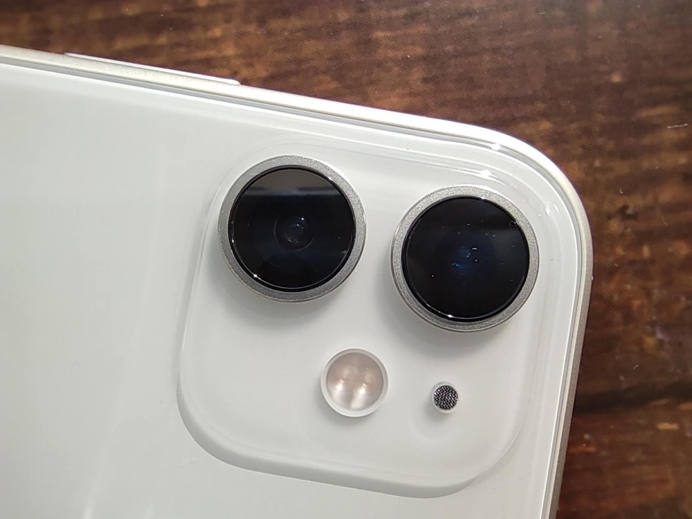 The white iPhone 11 dual camera area on the table