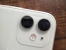 The white iPhone 11 dual camera area on the table